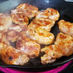 View of chicken thighs cooking