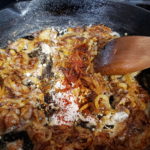 Picture of adding flour and spices to caramelized onions