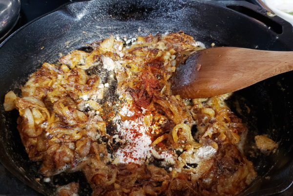 Picture of adding flour and spices to caramelized onions