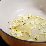 Sliced fresh garlic in olive oil with red pepper flakes