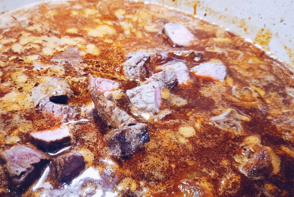 Picture of broth and beef added to stew.