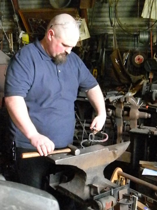 Picture of son doing a blacksmithing craft