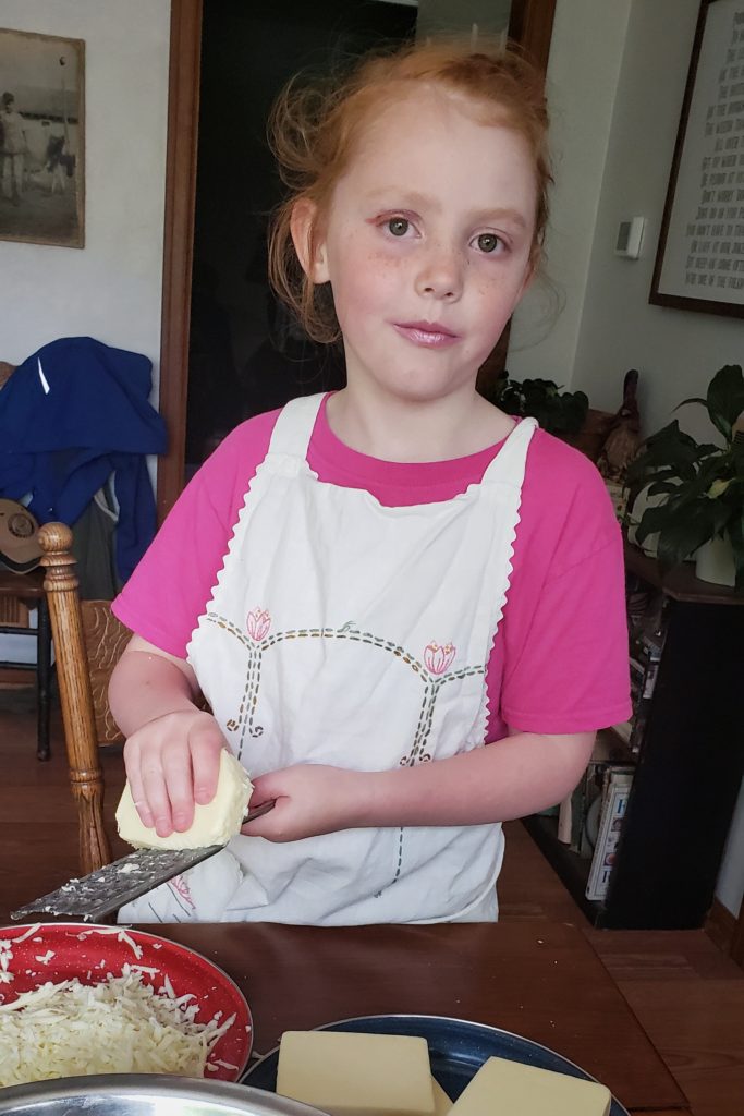 Picture of Granddaughter helping Grammie make a meal for a friend